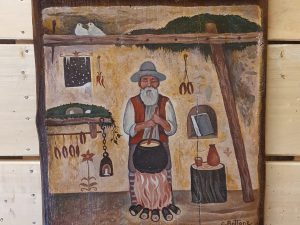 Pannello con Vecchio che gira la polenta